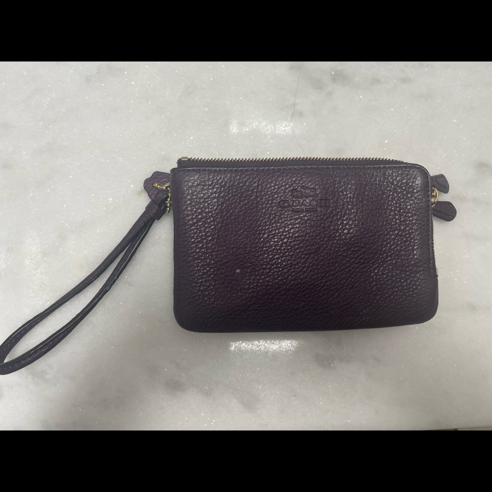 Plum colored coach wristlet